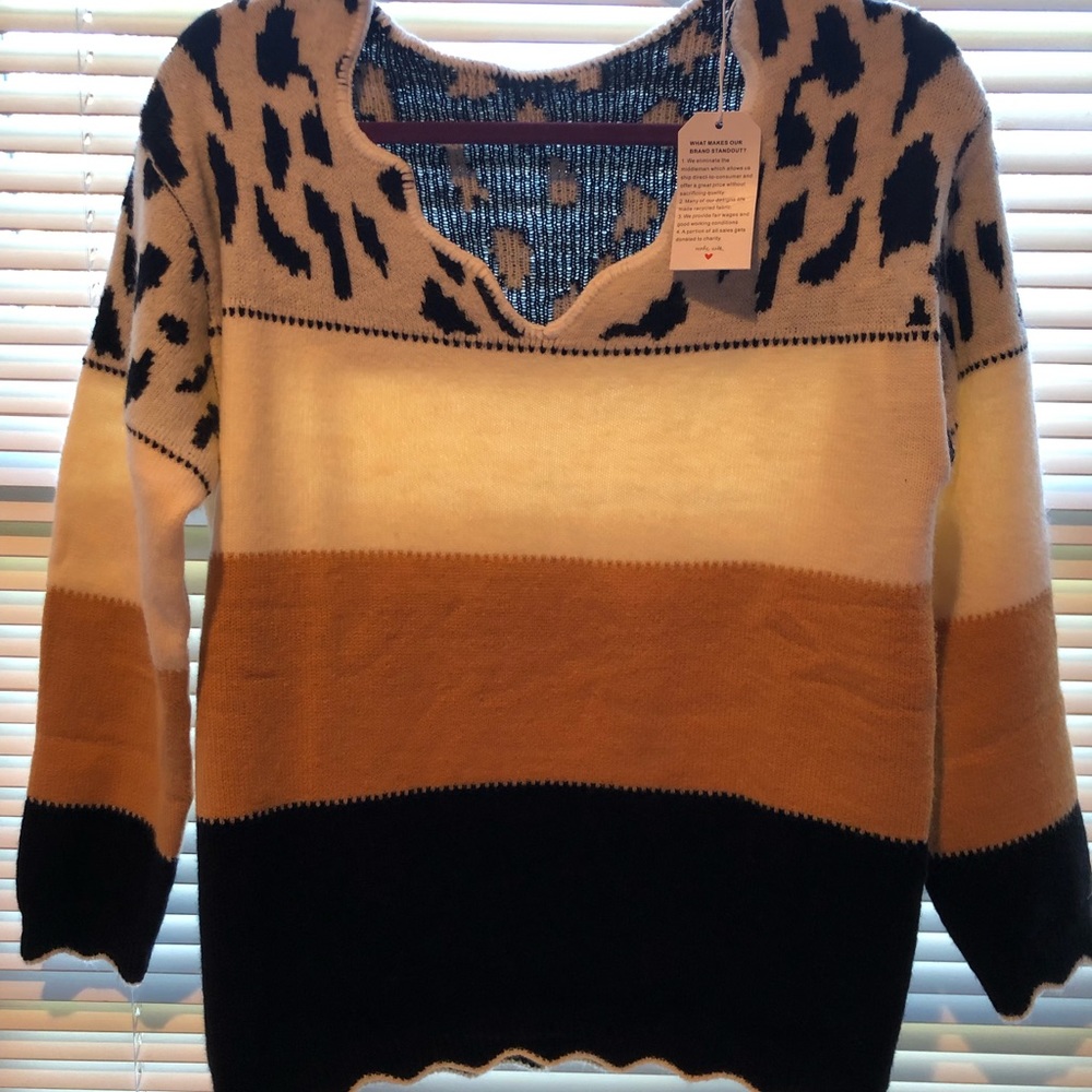 New w/tags never worn. Beautiful designer sweater women’s large.